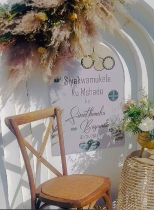 Floral arch and lounge seating